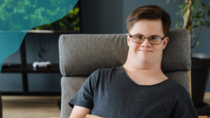 Ung kille med Downs syndrom ser rakt in i kameran